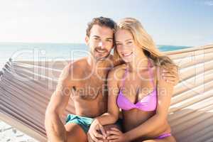 Smiling couple sitting in hammock