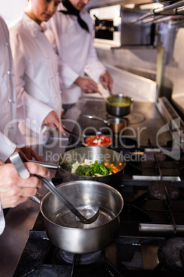 Group of chef preparing food in the kitchen