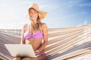 Woman using her laptop in hammock