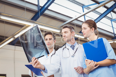 Concentrated doctors examining X-ray