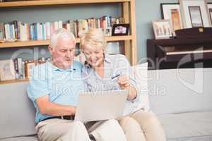 High angle view of senior couple using laptop