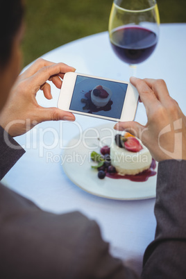 Woman taking a photo of her dessert