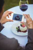 Woman taking a photo of her dessert