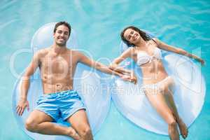 Happy couple relaxing on inflatable ring