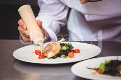 Chef putting sauce on a dish