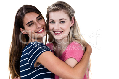 Portrait of cheerful female friends hugging