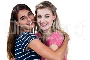 Portrait of cheerful female friends hugging