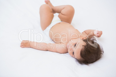 High angle view of cute baby lying on bed
