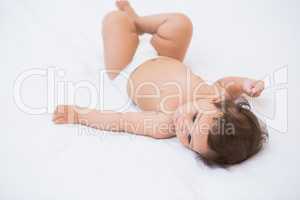 High angle view of cute baby lying on bed