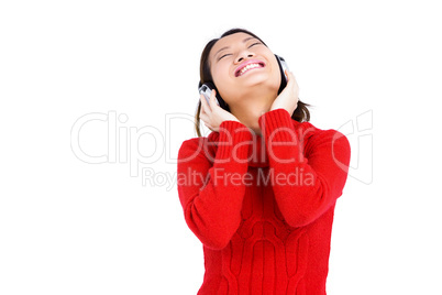 Young woman listening to music on headphones