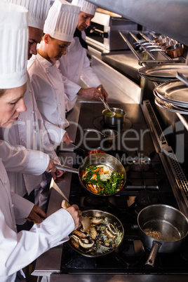 Group of chef preparing food in the kitchen
