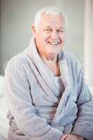 Portrait of smiling man wearing bathrobe