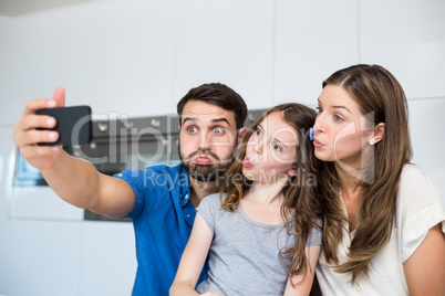 Family making faces while clicking selfie