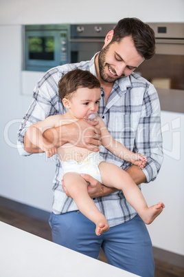 Father smiling while carrying son