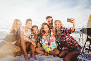 Happy friends taking selfie with smartphone