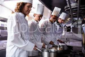 Chefs preparing food in kitchen