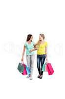 Smiling female friends holding shopping bags
