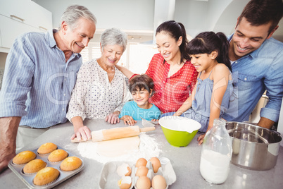 Happy family making bread in kitchen