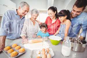 Happy family making bread in kitchen