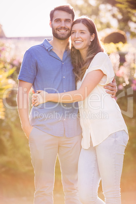 Young couple embracing and standing