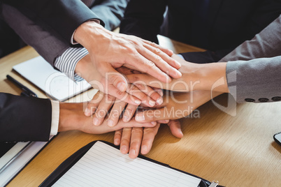 Close-up of businesspeople stacking hands