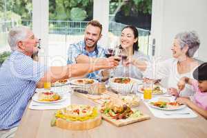 Happy family toasting red wine