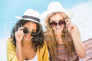 Young women wearing sunglasses having fun near pool
