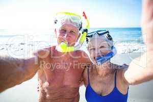 Senior couple with beach equipment