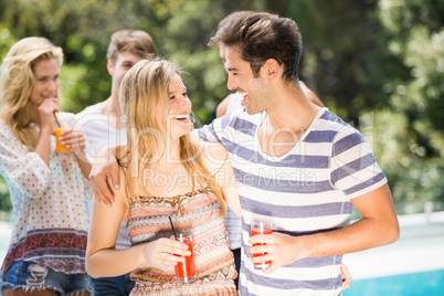 Young couple smiling and having juice together