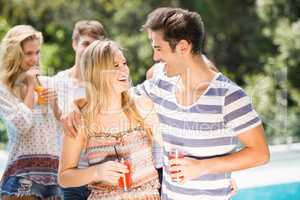 Young couple smiling and having juice together