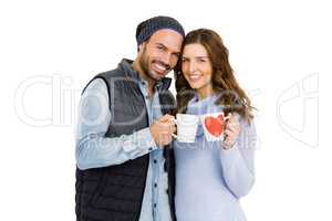 Happy young couple holding coffee mug