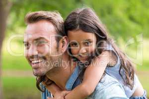 Young girl rides piggyback