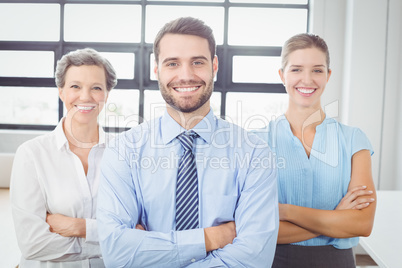 Cheerful business people with arms crossed