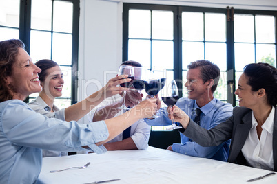 Group of businesspeople toasting wine glass during business lunc