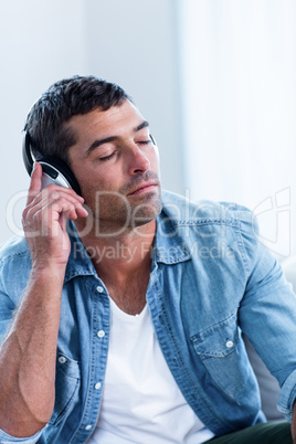 Young man listening to music on head phone