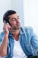 Young man listening to music on head phone