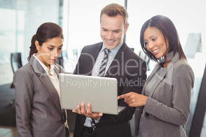 Businesspeople looking at laptop