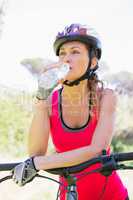 Woman drinking water on bike