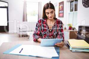 Beautiful young woman using digital tablet