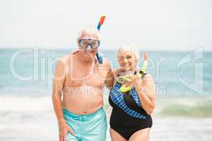 Senior couple wearing snorkel and diving goggles