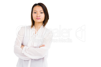 Angry young woman standing with arms crossed