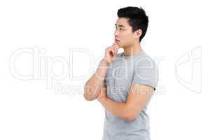 Young man thinking with hand on chin