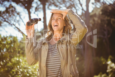 Smiling woman holding binoculars