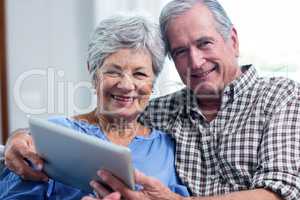 Portrait of senior couple using a digital tablet