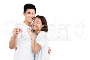 Happy young couple showing key