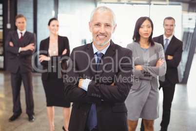 Businesspeople standing with arms crossed