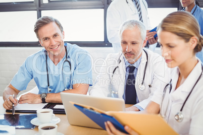 Male doctor smiling in conference room