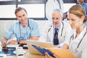 Male doctor smiling in conference room