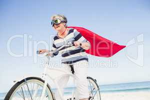 Senior superwoman on a bike
