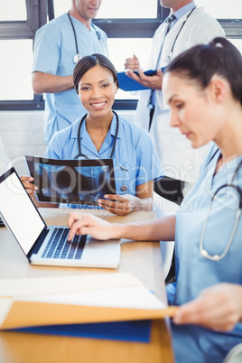 Doctor holding a x-ray report in conference room